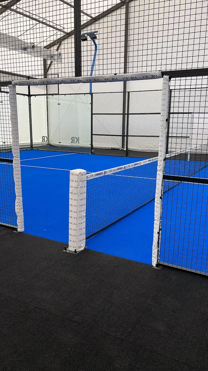 A modern, well-lit indoor padel court ready for a match.
